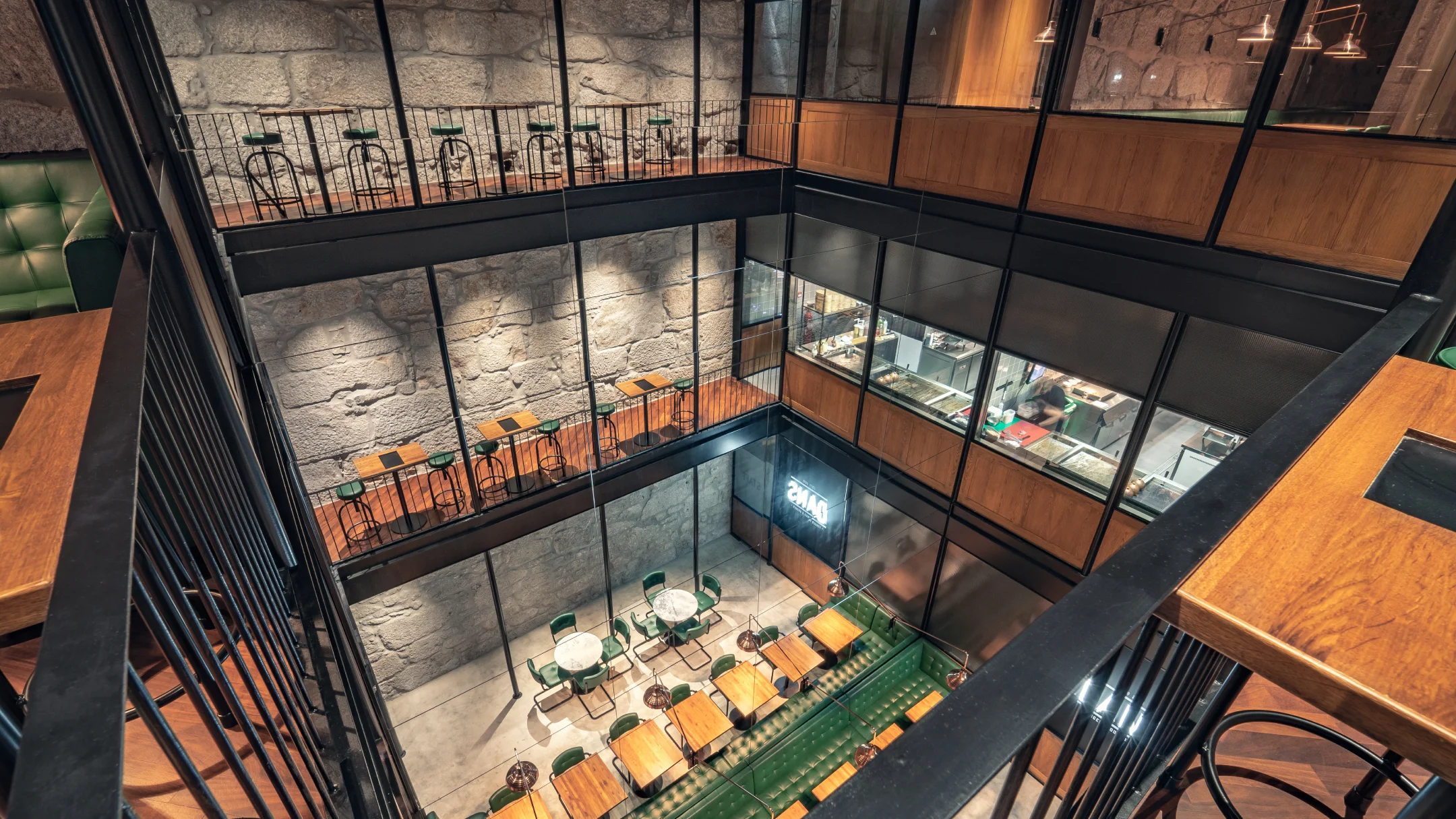 Nhdesign project DANS: Aerial view of DANS restaurant interior with tables and industrial design