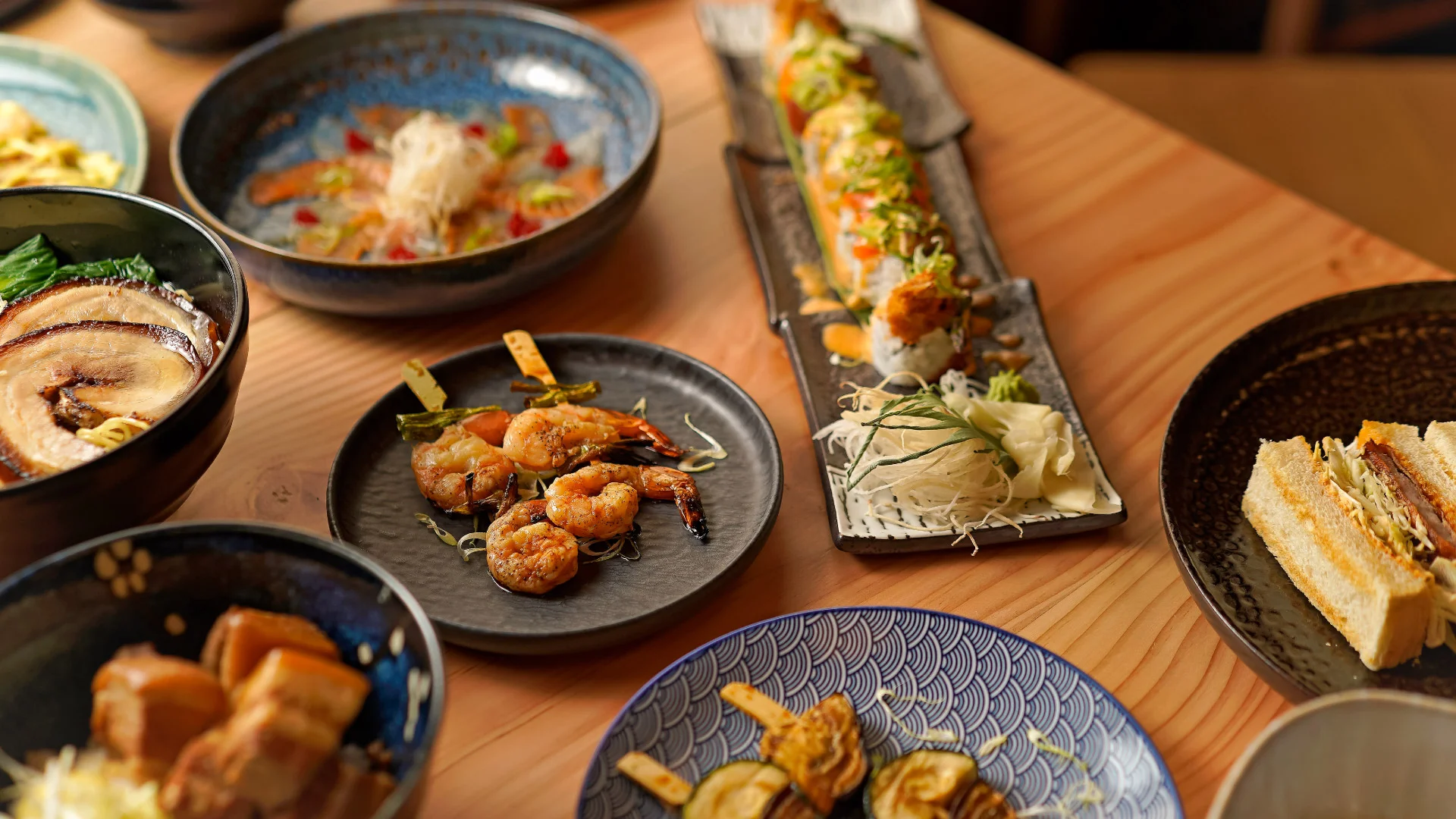 Nhdesign project Izakaya Matsuri: A variety of a Japanese dishes spread out on a table.