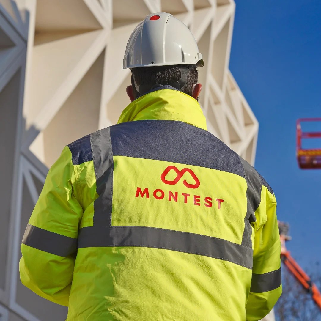 Nhdesign project Montest: Montest employee wearing branded reflective safety vest.