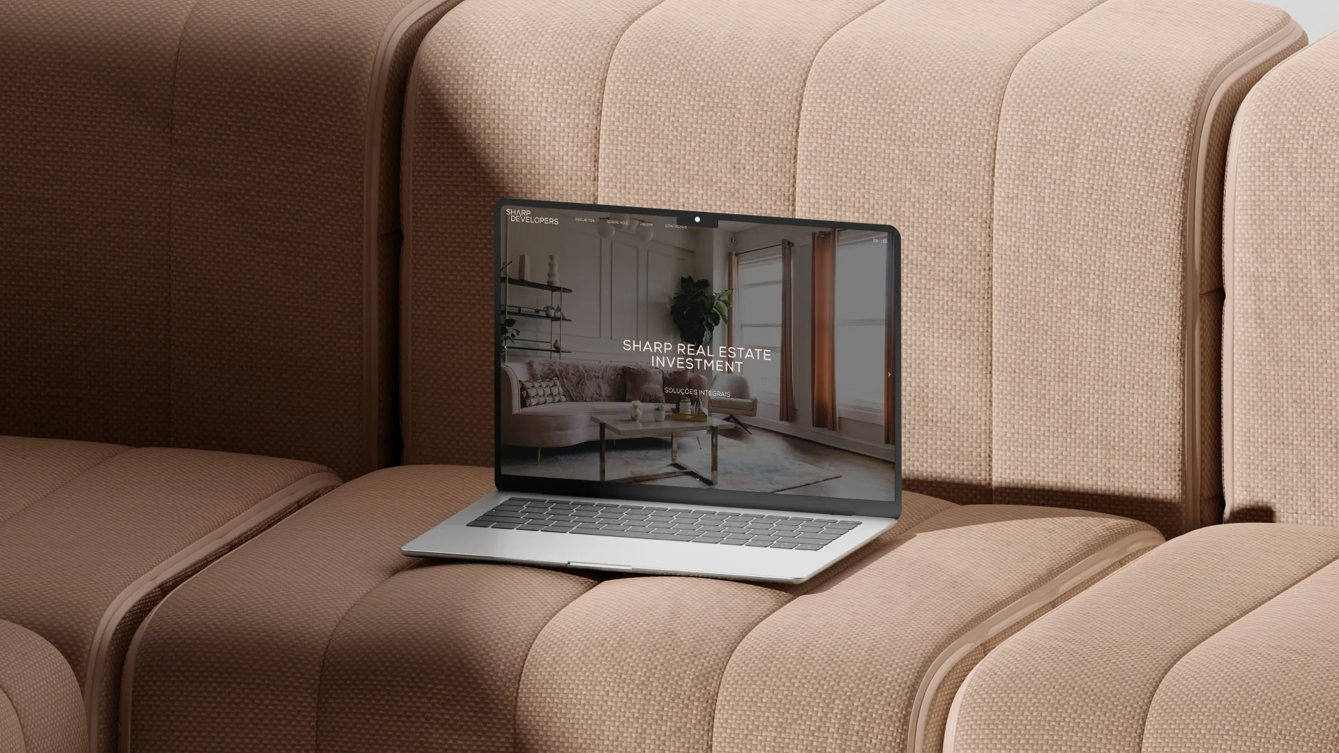 Nhdesign project Sharp Developers: Photograph of a laptop on a sofa with the Sharp Developers website open.
